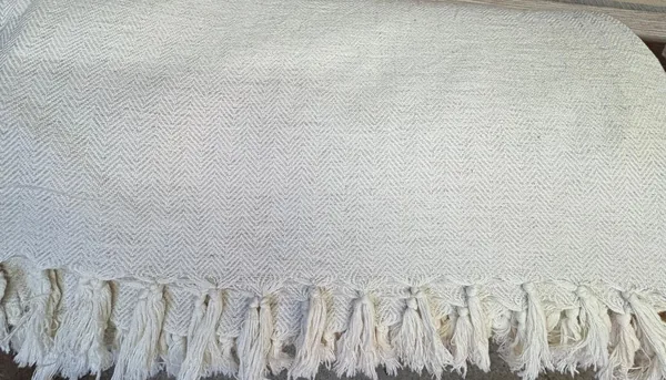Turkish pike coverlet — cotton-linen herringbone weave with hand-tied tassels