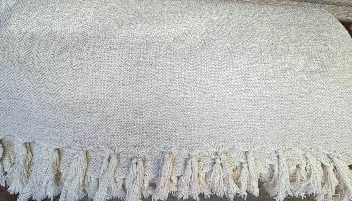 Turkish pike coverlet in natural cotton-linen herringbone weave with hand-tied tassels